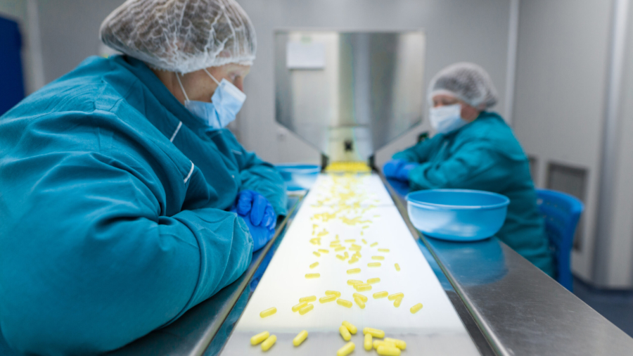 two pharmaciutical women working on line with pills